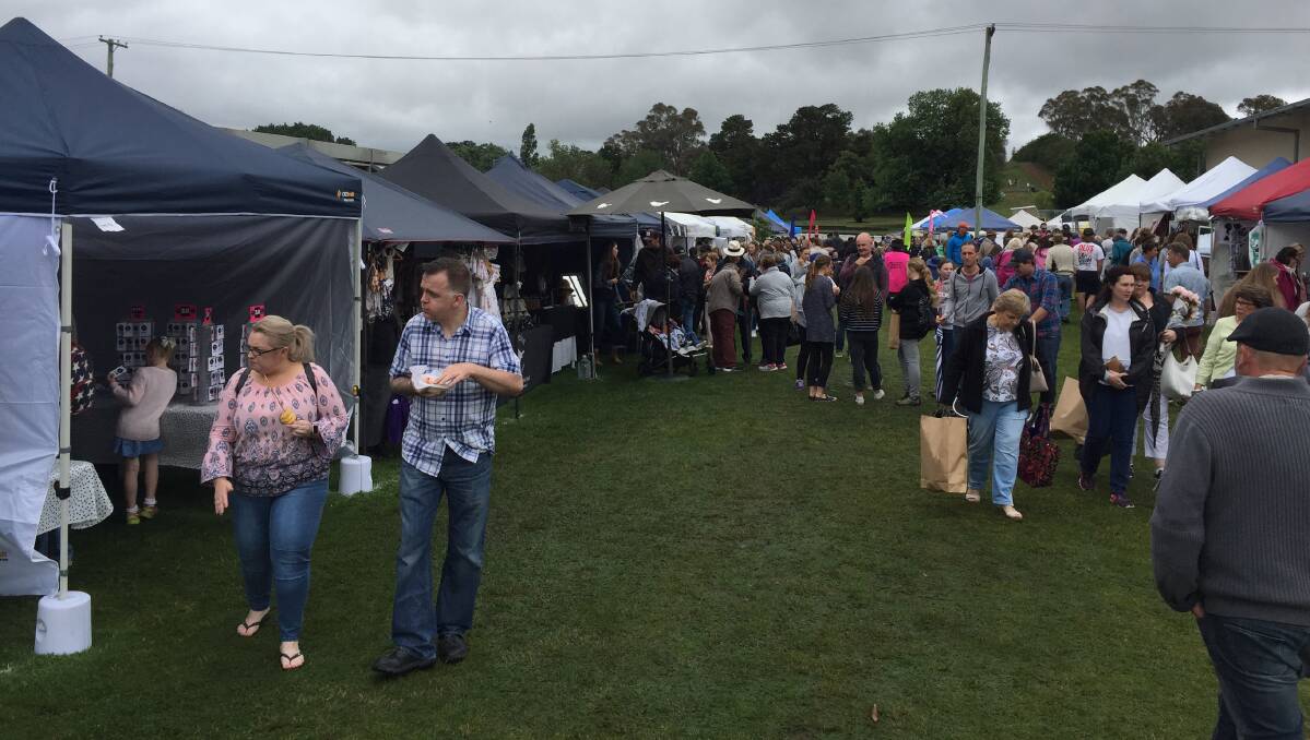 STILL POPULAR: Ominous clouds and damp conditions failed to repel the fans of the Millthorpe Markets. The next market is scheduled for Sunday, April 8 next year. Photo MARK LOGAN