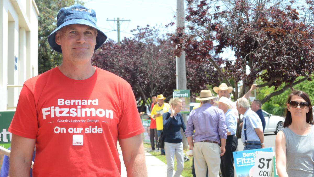 Labor supporter Toby Tancred was handing out how to vote cards in Molong on Saturday. Photo: LYNN PINKERTON