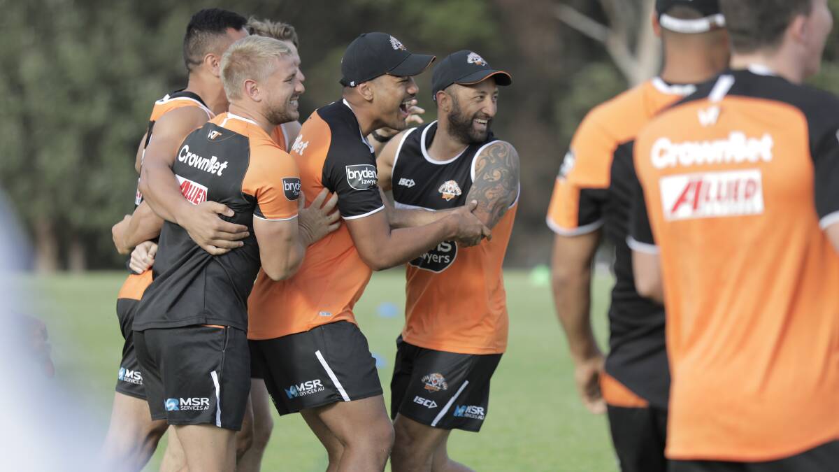 GET AROUND US: Benji Marshall (right) is back in Tigers colours for the 2018 NRL season, which stars on Thursday night. Photo: AAP