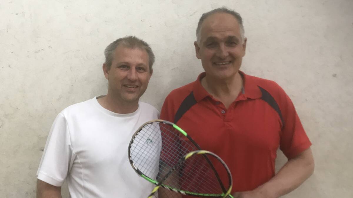 WHAT A BATTLE: Orange Wednesday night squash regulars Grant Michell and Charles D'Aquino. Photo: CONTRIBUTED