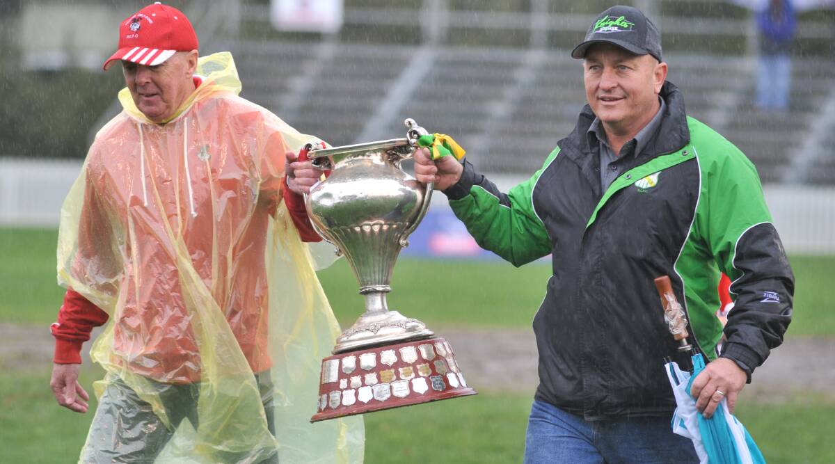 SPREAD ITS WINGS: The Challenge Cup, pictured with CYMS president Dave Penny and last year's Mudgee boss Rob O'Connor. Photo: JUDE KEOGH