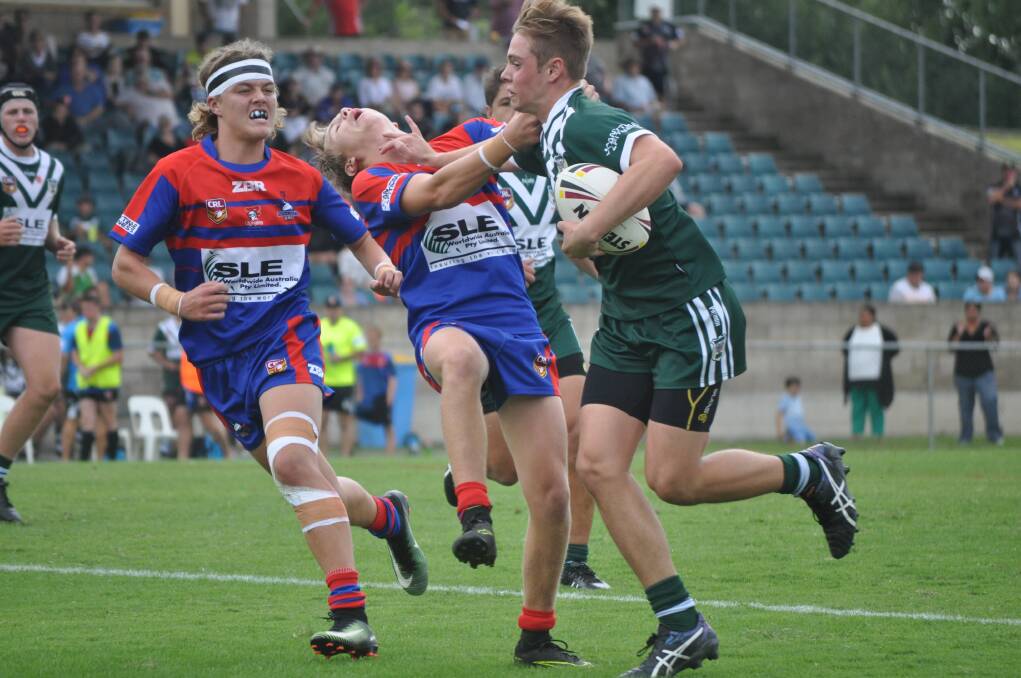 BANG: Coopa Martin gives the Newcastle defence a massive don't argue during Western's under 16s semi-final win at Carrington Park. Photo: NICK McGRATH