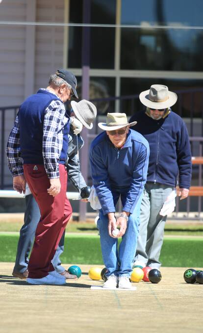 WORKING AS A TEAM: Barry O'Donnell, Doug Hillier, Reg Sharpe and Bob Ridgewell at Orange Ex-Services Country Club bowling green last week. Photo: PHIL BLATCH