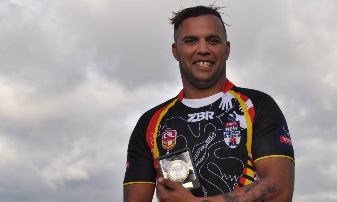 HAPPY: Jeremy Gordon accepts the Terry Brown medal for man of the match. Photo: NICK McGRATH