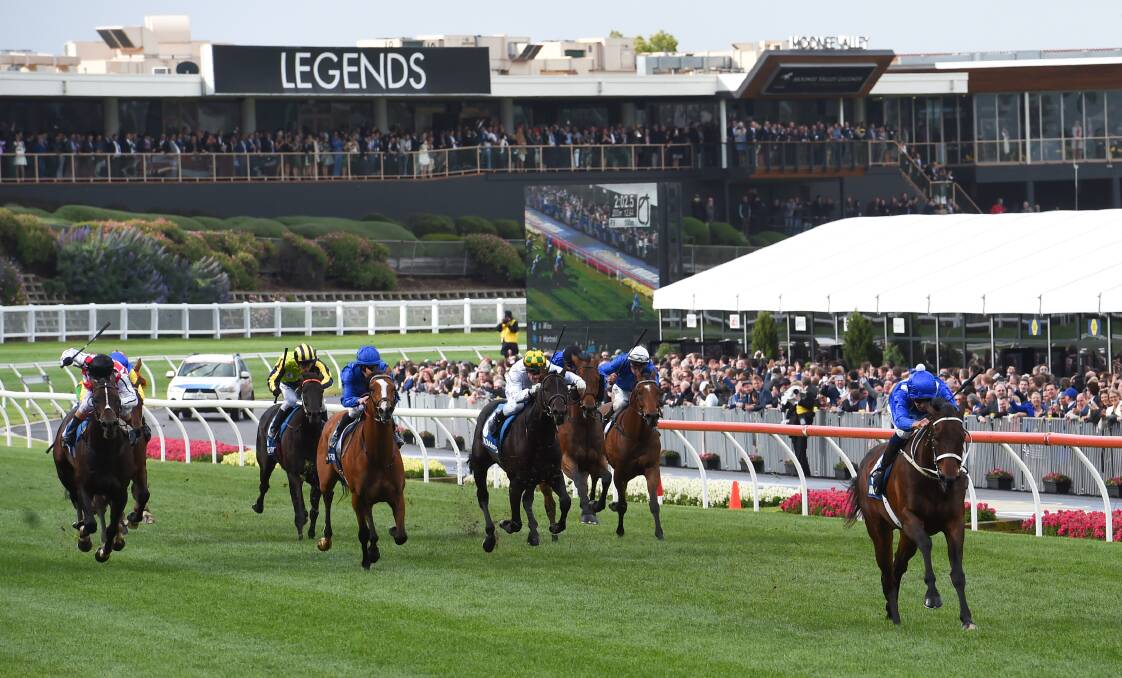 BLINK AND YOU'LL MISS THEM: Winx and Hugh Bowman put a gap on the chasing pack in Saturday's Cox Plate at Moonee Valley.
