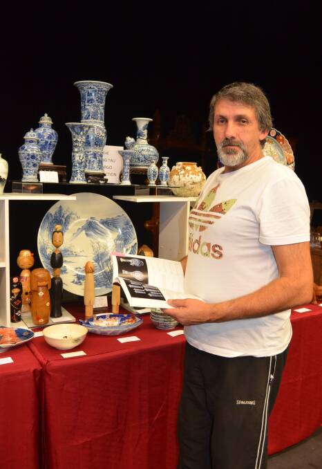 SETTING UP:  Spirit of Asia Antiques owner Mario Cordedda with Chinese artifacts from 1690 that were salvaged from the Vung Tau shipwreck. 