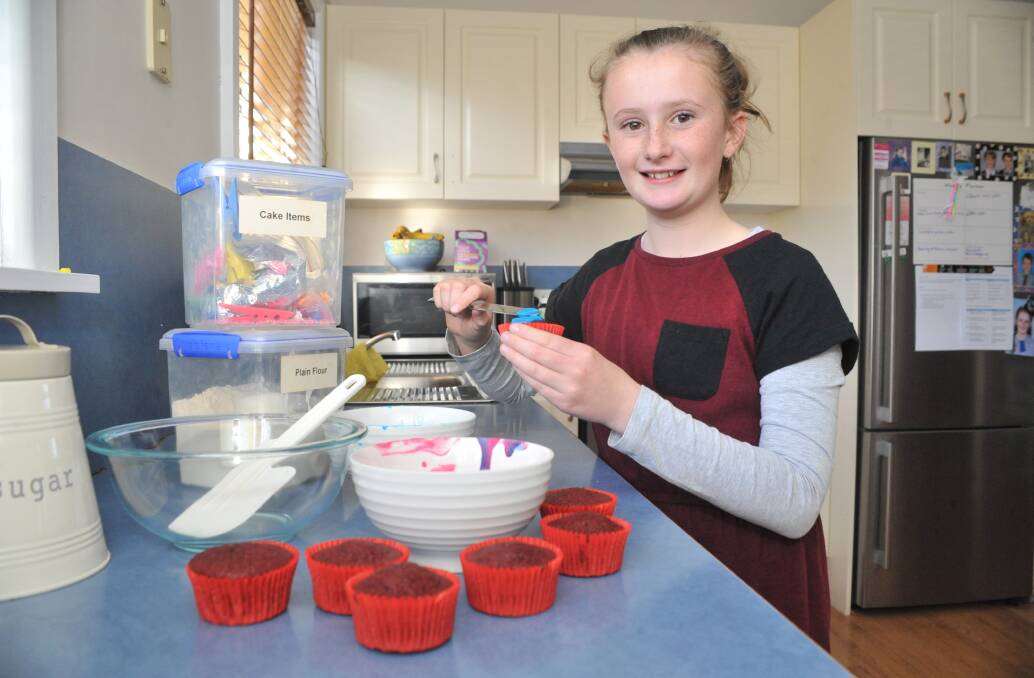CUPCAKE CHAMPION: A love of animals has led to 10-year-old Haylee Kennedy spend hours baking and decorating cupcakes to sell to fellow pet owners and raise money for the RSPCA. Photo: JUDE KEOGH 0907jkcupcakes1