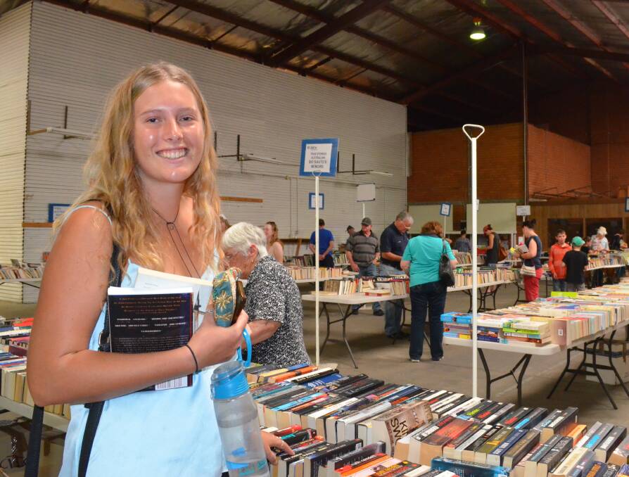 BOOKS GALORE: Caitlin Brindley shopped for books at the Lifeline charity book fair last Saturday. Photo: TANYA MARSCHKE 1119tmbook3