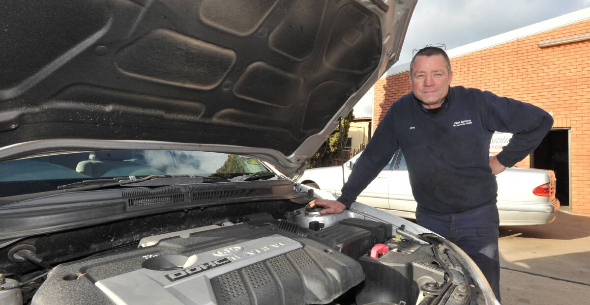 SAFETY FIRST: John Spicer's Mechanical Repairs owners John Spicer is urging drivers not to leave their registration check to the last minute. Photo: JUDE KEOGH 0825jkmechanic2