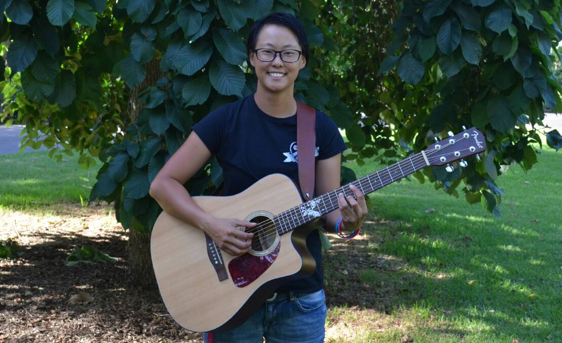 A GIRL AND HER GUITAR: Musician Mel Yeates is hoping to raise money and awareness of depression, suicide and cancer when she performs in Orange as part of a national busking tour. Photo: SUPPLIED