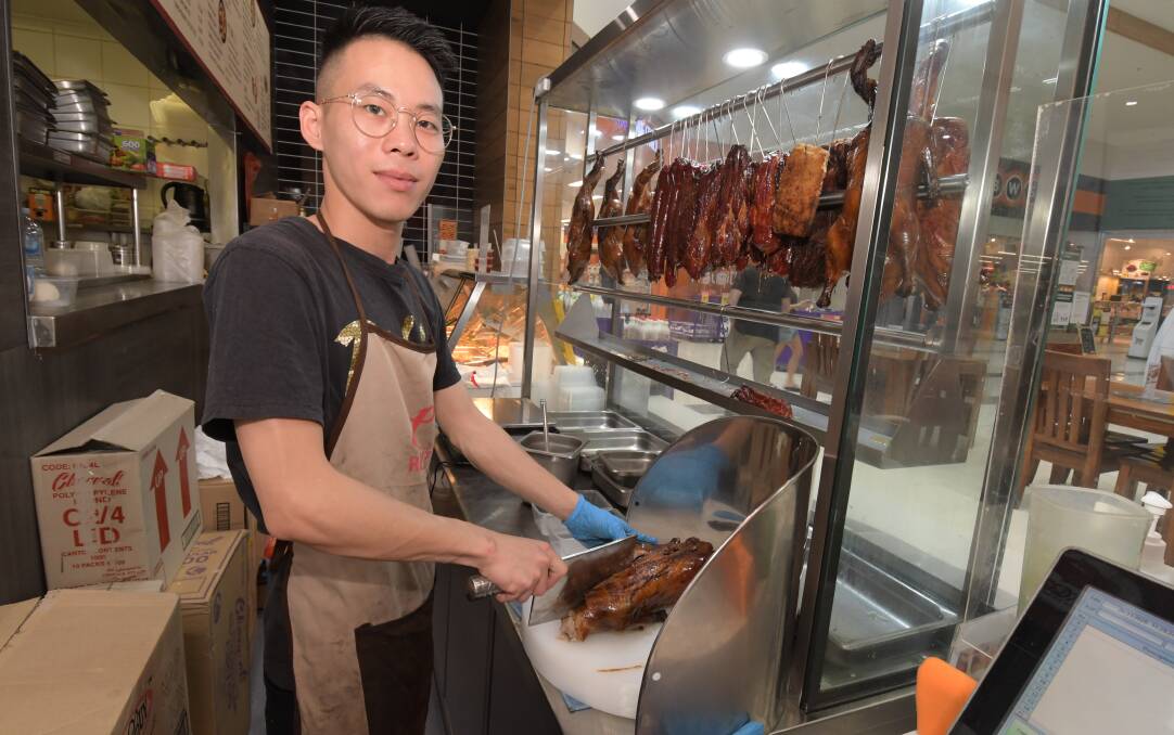 POPULAR: David Zhou preparing the duck at Fresh Food Fast. Photo: JUDE KEOGH