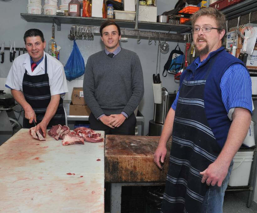 PERSERVERANCE: Woodward Street Quality Meats owner Jay Parkes and Job Centre Australia marketing consultant Callan Hunt with Josef Pedrsen, who found work despite a brain injury. Photo: JUDE KEOGH 0706jkbutcher4