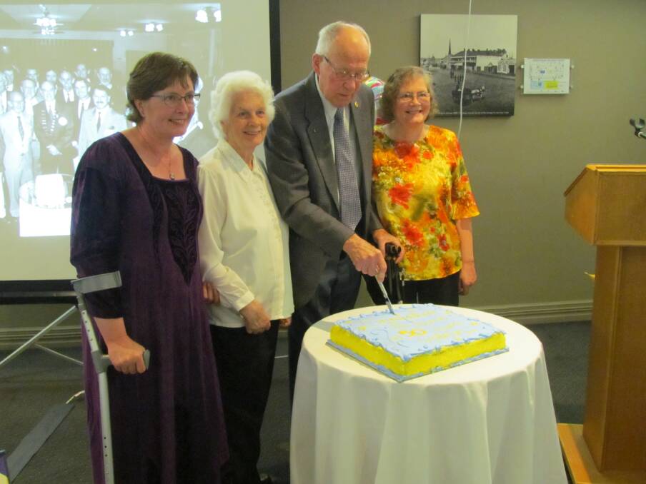 LONG SERVICE: Annette Thorncraft, Valda and Jim Heron and Rhonda Redenbach cut the cake to celebrate Jim’s 50 years of service to the Rotary Club of Orange.