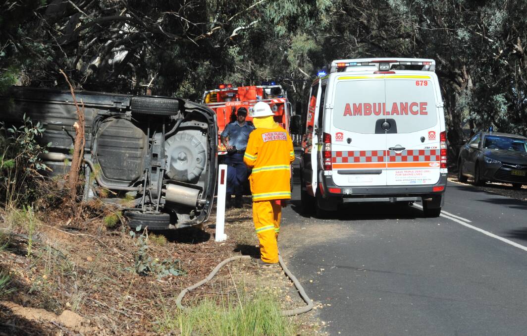 SLOW DOWN: Emergency crews at the site of a car crash on Ophir Road in May. Photo: Declan Rurenga