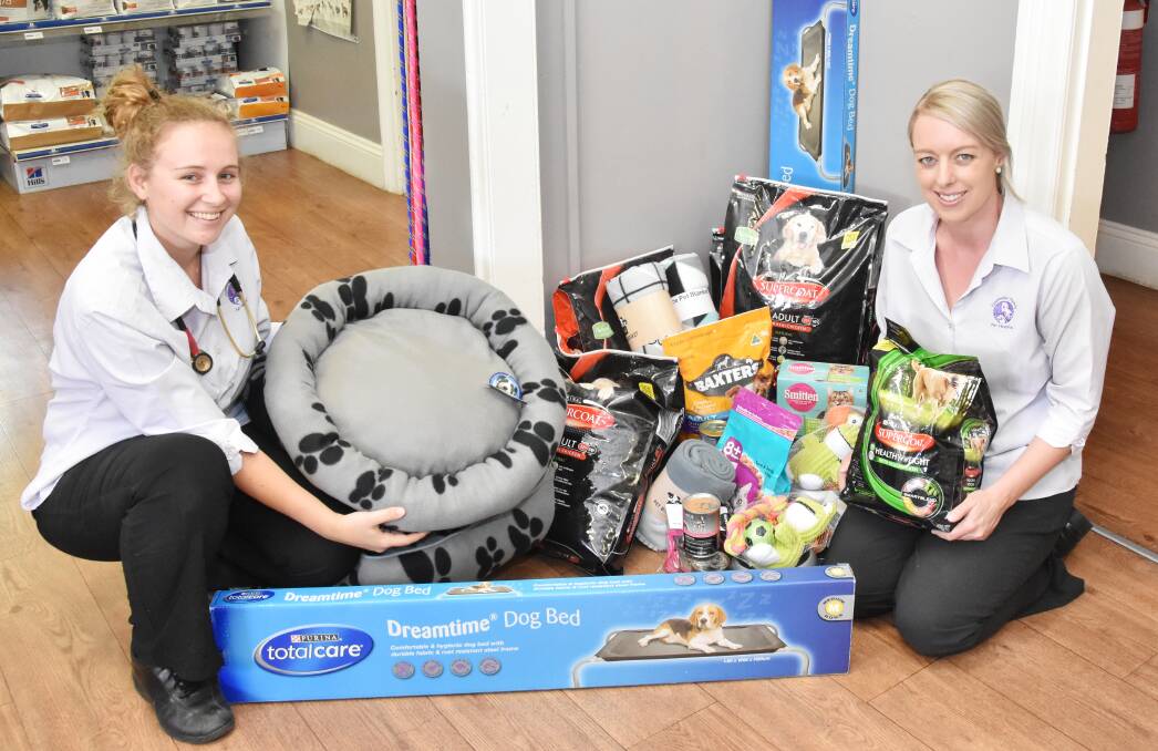 SEEKING DONATIONS: Canobololas Family Pet Hospital vet Lauren Slater and vet nurse Cass Scurrah are collecting pet food donations for those affected by fire near Dunedoo. Photo: SUPPLIED