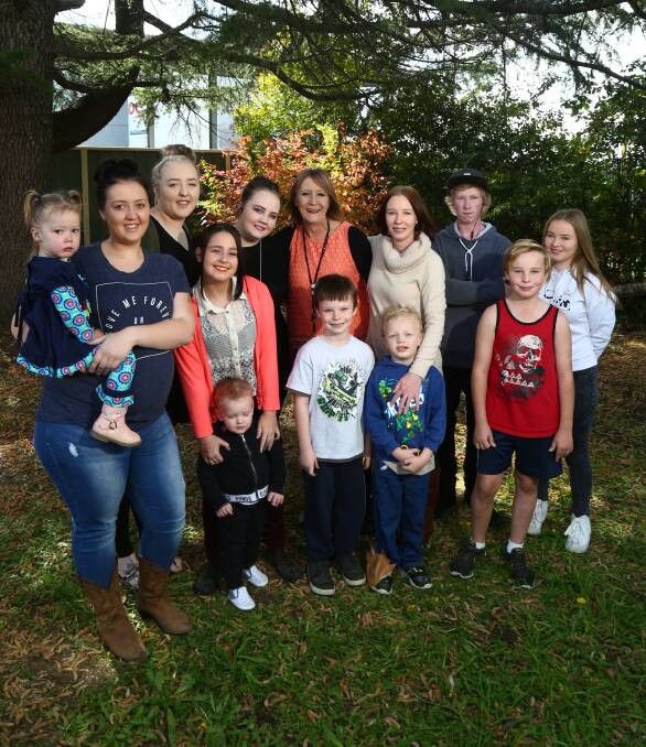 FAMILY FOCUS: Karlie Irwin and Mel Flannery (centre) with some of their offspring, Jacinta Irwin holding Gracie Langbein, Trinity, Mikayla and Karlie Irwin and Mel Flannery, Mitchell and Mickayla Flannery. Front, Christy Newport with Leon Jones, Riley Flannery, Zac and Blace Flannery.. Photo: PHIL BLATCH