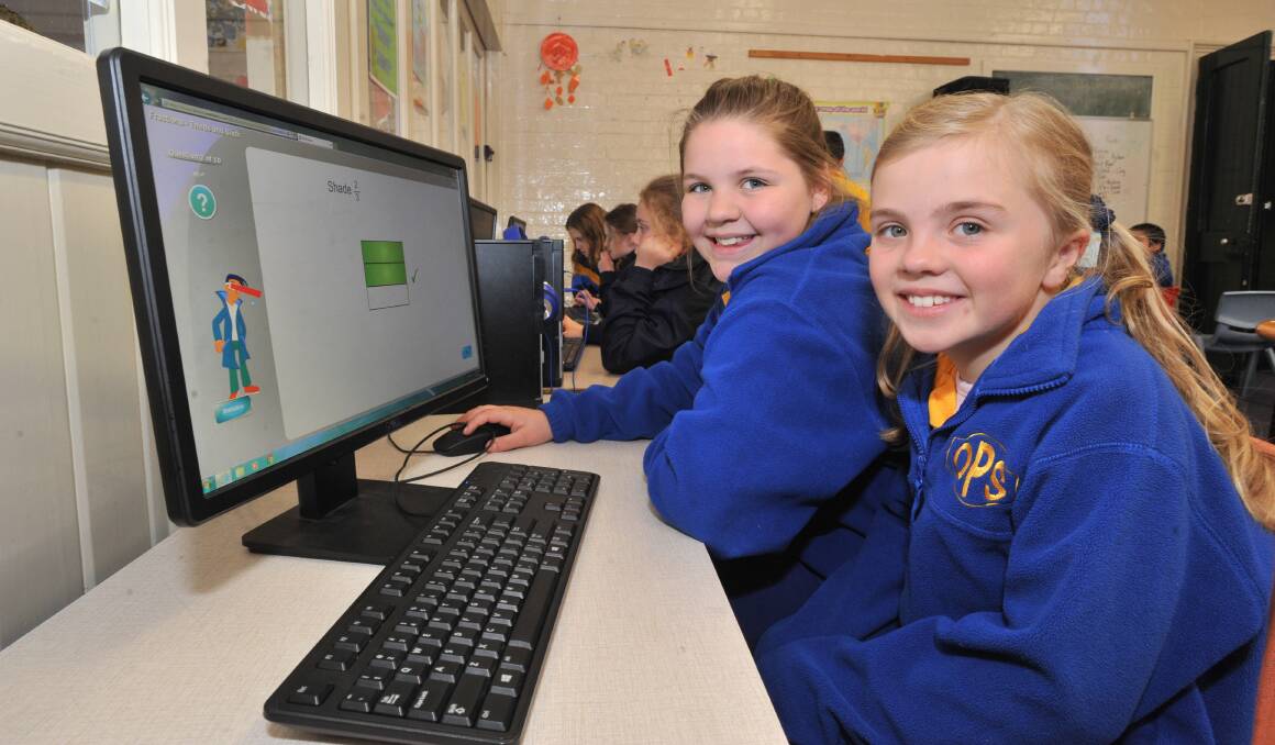 PENS DOWN: Orange Public School students Lara Campbell and Charlotte Jackson could complete their future NAPLAN tests using computers. Photo: JUDE KEOGH
