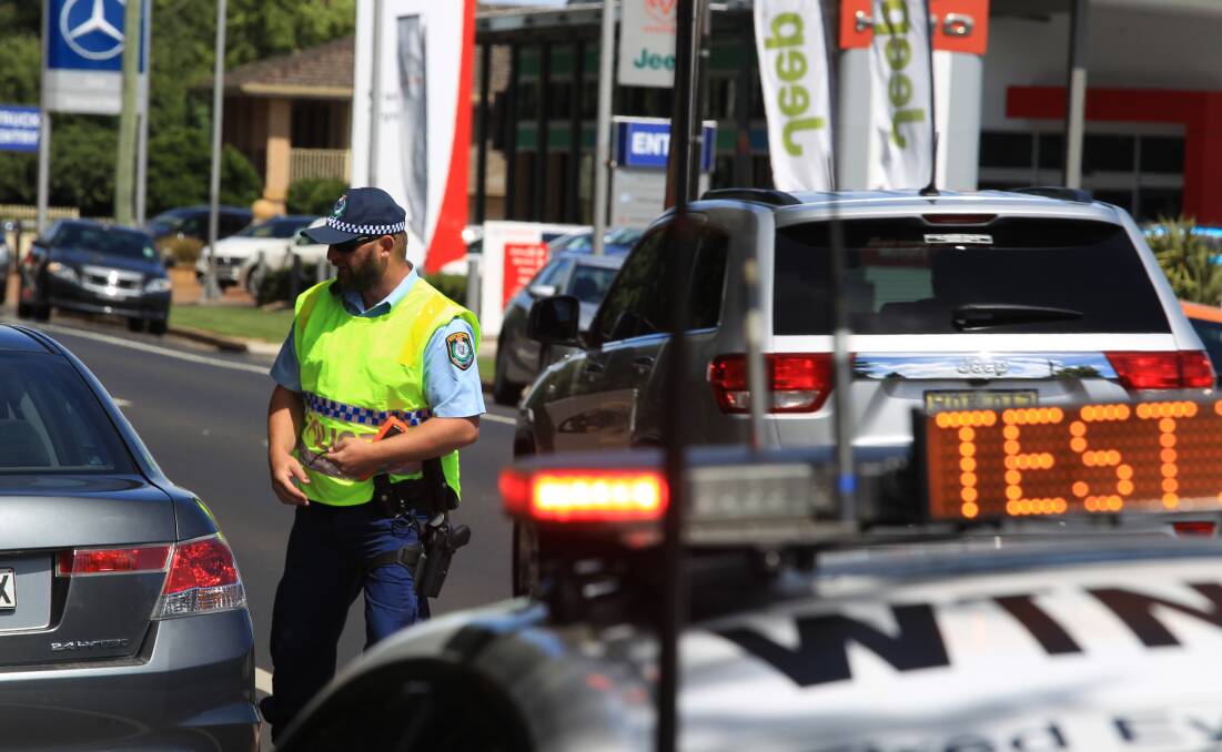 CHANGES PROPOSED: Senior Constable Bart Czyzcwski breath-testing and checking speed on the Escort Way. FILE PHOTO