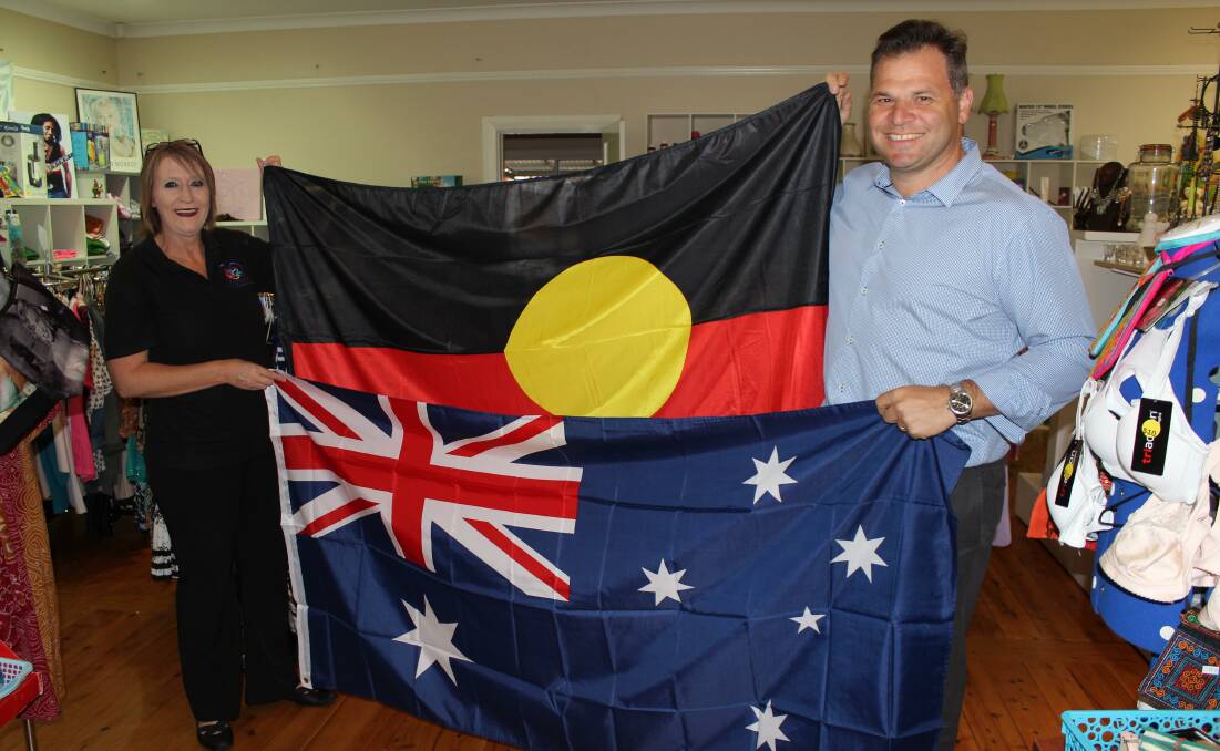PAYING IT FORWARD: Pay it Forward founding director Karlie Irwin was presented with replacement flags by Member for Orange Phil Donato on Tuesday. Photo: SUPPLIED