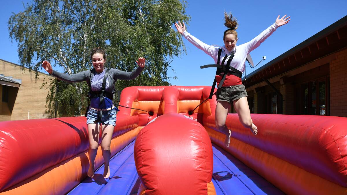 JUMPING INTO EDUCATION: Laura Duncan and Lauren Mason got active during the Orientation Week activities at Charles Sturt University on Tuesday. Photo: JUDE KEOGH