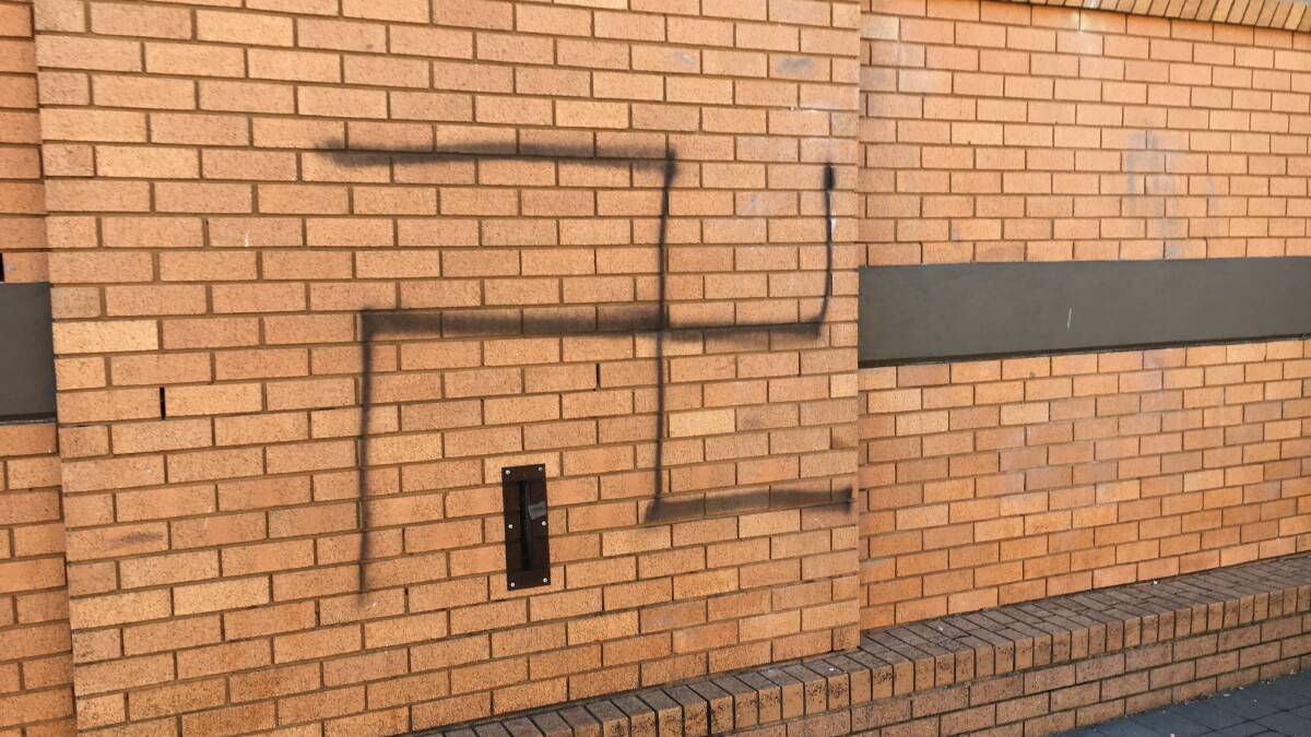MESSAGE OF HATE: A swastika was one of several symbols and messages sprayed onto the walls of James Sheahan Catholic High School. Photo: SUPPLIED