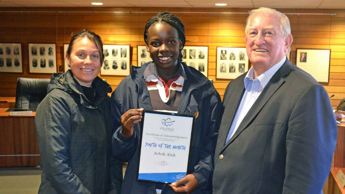 ROLE MODEL: Orange City Council youth development officer Katrina Hausia, Youth of the Month August 2016 recipient Achok Aluk and Orange City Council Mayor John Davis. Photo: SUPPLIED