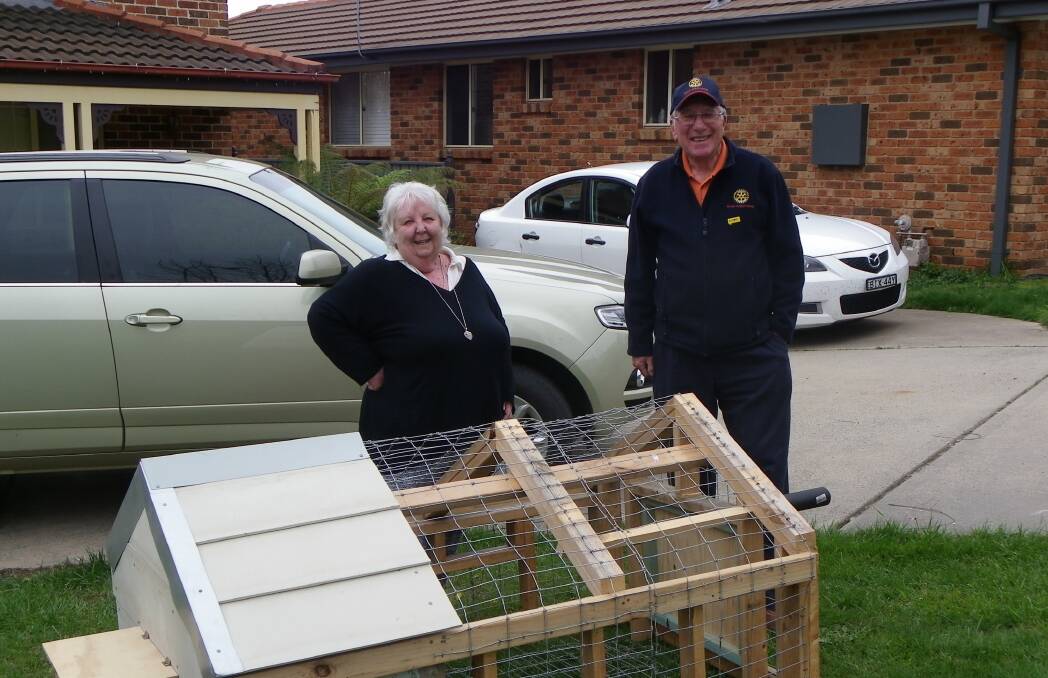 WINNERS ARE GRINNERS: Chook tractor raffle winner Joan Riley with Rotary Club of Orange member John Templeman and her new chook tractor. PHOTO: Contributed