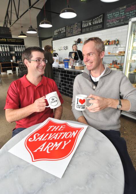 CUPPA FOR A CAUSE: Captain David Grounds and Nick Gleeson have a cup of coffee ahead of the Salvation Army Red Shield Appeal door knock this weekend. Photo: JUDE KEOGH 0524jkcoffee2