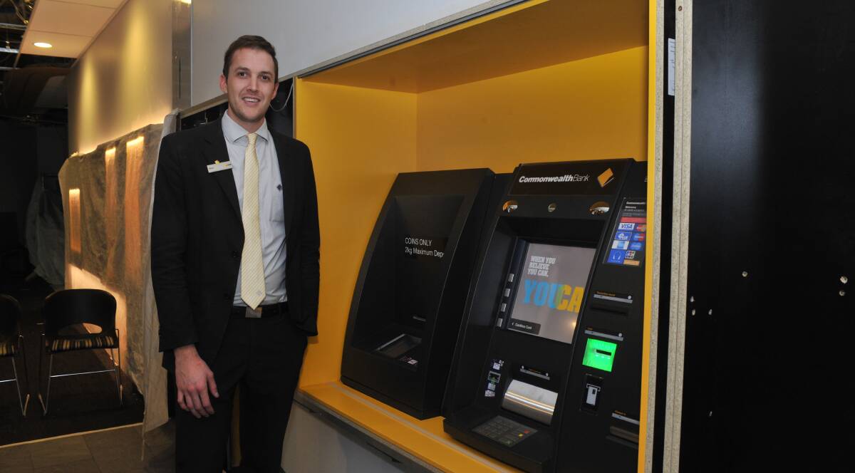 NEW FACILITIES: Commonwealth Bank business banking specialist Dion Milligan next to one of the new indoor ATM machines. Photo: JUDE KEOGH 0623jkcommonwealth1