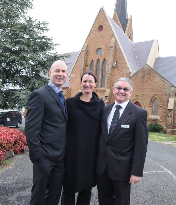 LOOKING TO THE FUTURE: New headmaster Reverend Louis Stringer, Dee Stringer and school council chair Greg Catto in front of Holy Trinity Anglican Church. Photo: STEVE GOSCH 0623sgangnews2