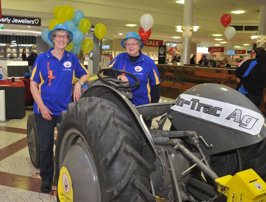 START YOUR TRACTORS: Camp Quality volunteers Sue Moffatt and Louise Eggleston started the fundraising efforts at the Orange City Centre as a part of the centre's three-day mega sale. Photo: JUDE KEOGH 0623jktractor2