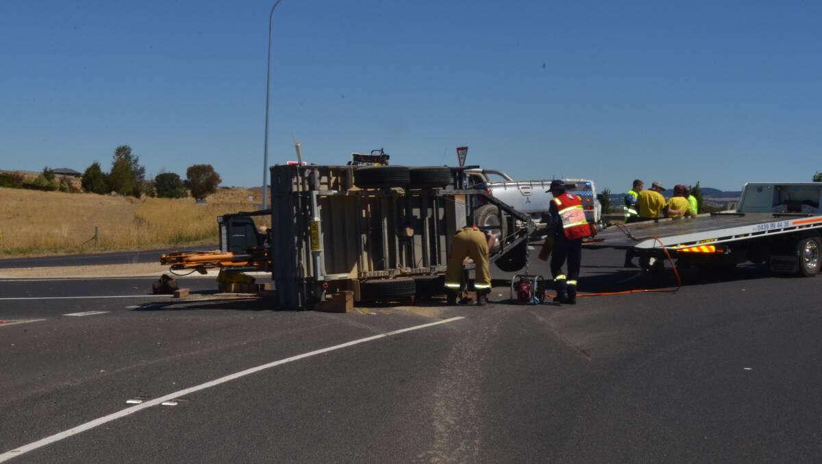 TRAILER TIP OVER: A ute pulling a trailer with an excavator on board crashed on Northern Distributor Road on Tuesday afternoon. Photo: EMILY BENNETT