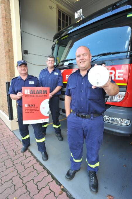 A FRIENDLY REMINDER: Phil Pedley, Mark Bell and Dane Philippe have asked people to check their smoke alarms this weekend. Photo: JUDE KEOGH 0329jkfire2