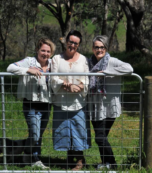 SUPPORT AND SOLIDARITY: Banika Smee, Bernie Novotny and Kellie Grant stand in Mrs Novotny's backyard, which is the backdrop for the calendar. PHOTO: JUDE KEOGH