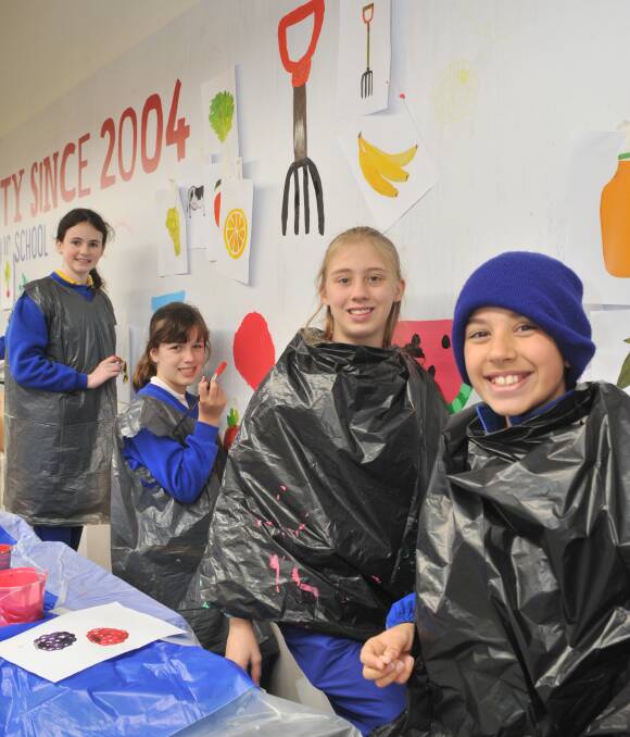 YOUNG ARTISTS ON SHOW: Bletchington Public School students Maddie Bryant, Paige O'Reilly, Paige Cooze and Sam Kiho in the new section of Harris Farm Markets. Photo: JUDE KEOGH0624jkharrisfarm2