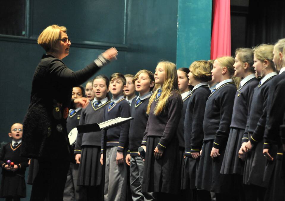 LAST SONG: Mary Fisk conducted the Orange Public School choir for the final time at the City of Orange Eisteddfod on Thursday. Photo: JUDE KEOGH