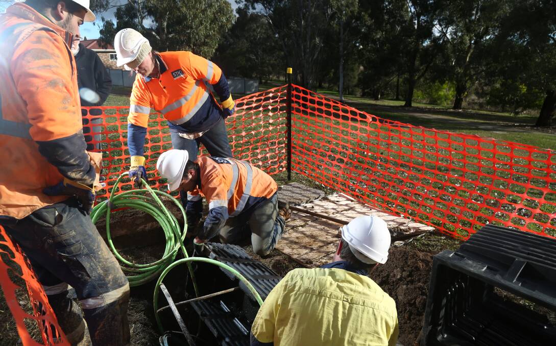 SWITCH ON: Todd Champs, Kedan Reti-Champs, Travis Cornellissens and Jamahl Wright working on the NBN. Photo: PHIL BLATCH
