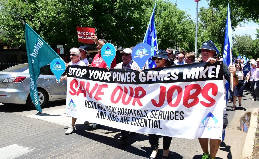 NOT HAPPY: Community members and trade unionists march along Macquarie Street in Dubbo on Saturday. Photo: BELINDA SOOLE