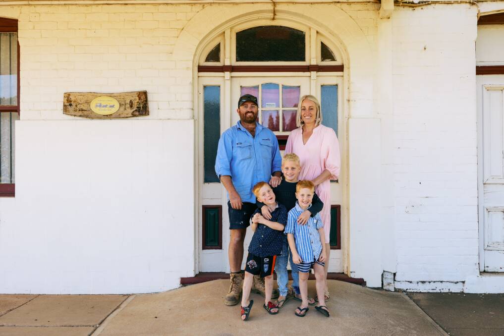 James and Emily Stanton with their sons Carter, Archie and Darby, outside the old Nyngan Hotel. Picture supplied