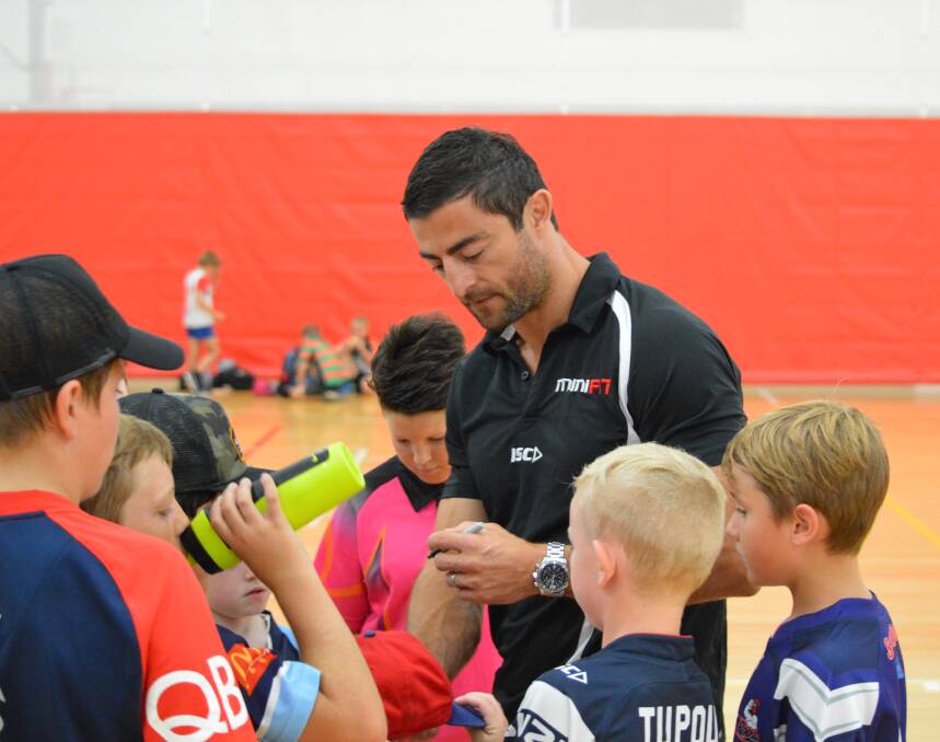 PRIZED SIGNATURE: Anthony Minichiello signs a jersey on Friday, his Minifit camp was a huge success. Photo: MATTHEW FINDLAY