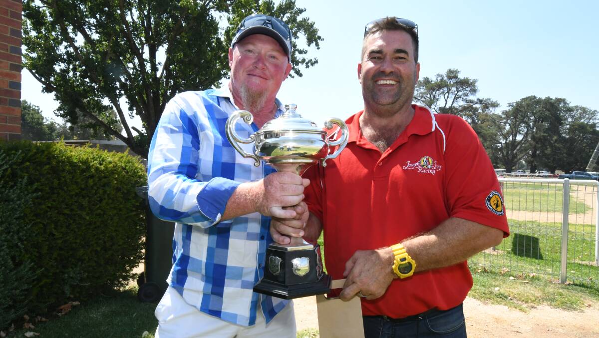 CUP WIN: Wayne Stokes and Matt Jones, from Canberra's Joseph-Jones Racing, show off their spoils from Saturday's feature race. Photo: JUDE KEOGH