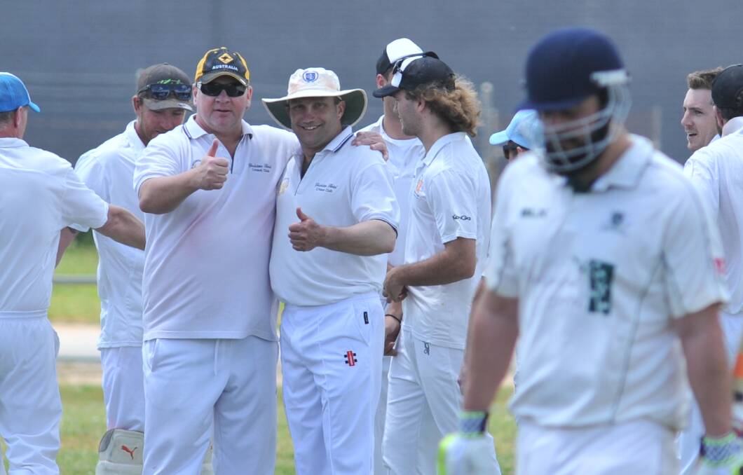 BETTER DAYS: Gladdy stalwarts Greg Goodlock and Scott Barrett flash a thumbs up last summer, after their side dismissed Orange City's Pat Giuffre (foreground). Photo: JUDE KEOGH