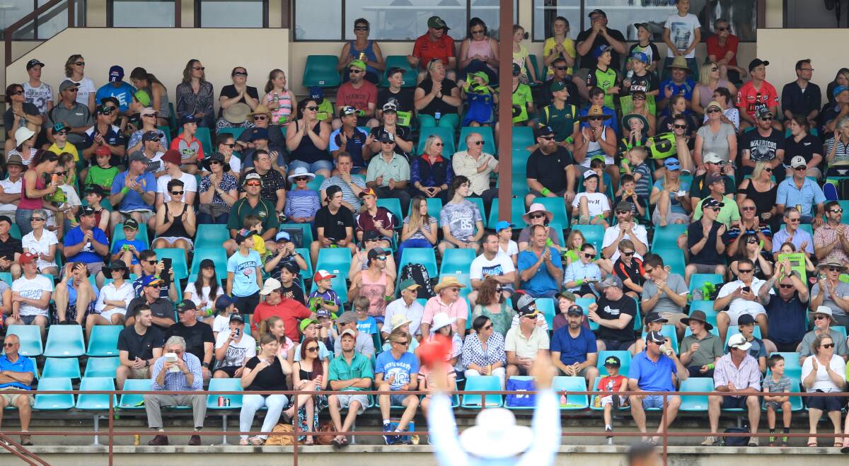 HORNS UP: The enthusiastic Wade Park crowd watches on as the umpire signals Eoin Morgan's gigantic six over midwicket. Photo: PHIL BLATCH