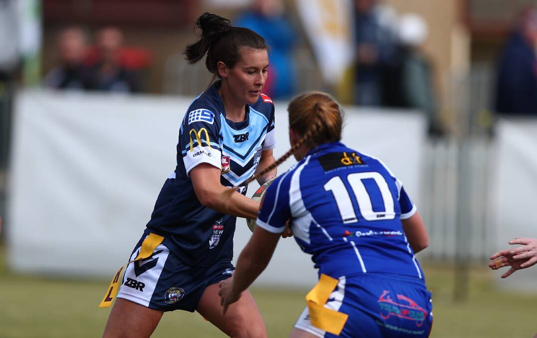 BOUNCE BACK: Amanda Livingstone carries in last weekend's loss to St Pat's, her Hawks side has one more chance to earn a grand final appearance. Photo: PHIL BLATCH