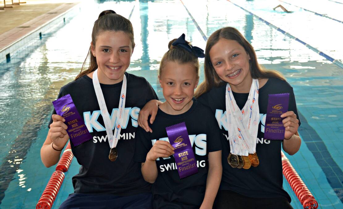 STARS-IN-WAITING: Kinross' Gabby Shilling, Lottie O’Herir-Corones and Collette Lyons show off their spoils from last weekend's state age championship. Photo: MATT FINDLAY