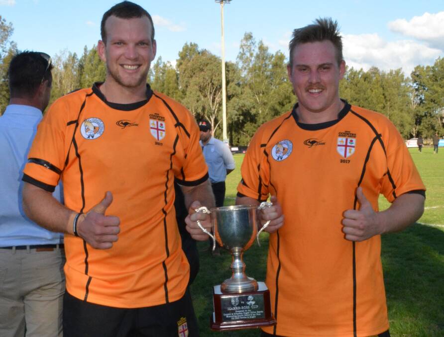 CHAMPIONS AGAIN: Parkes' Dan Ryan and Forbes' Charlie French show off NSW Country's spoils from last weekend - the Maher-Ross Cup. Photo: ALLAN RYAN