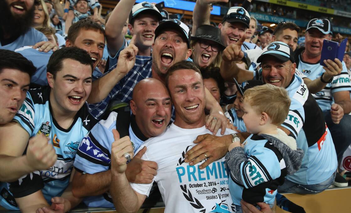 PORCH LIGHTS OFF: James Maloney celebrates Sunday's drought-breaking grand final win with Sharks fans at ANZ Stadium. Photo: GETTY IMAGES