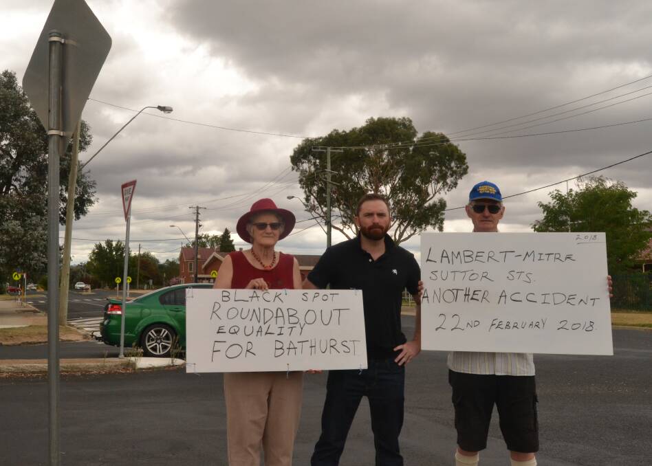 ROUND IN CIRCLES: Councillor Alex Christian (centre) with roundabout campaigners Dianne and Kent McNab at the West Bathurst intersection.