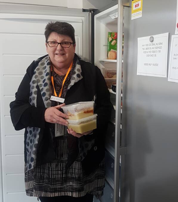 FOOD FOR THOUGHT: Volunteer Narelle Gordon stocks the fridge.