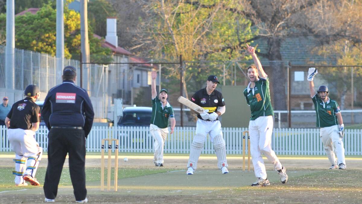 HO0WZAT: Orange City (in green) appeal for a wicket off the bowling of Jackson Coote (centre) on their way to a season-opening win at Wade Park on Friday night. Photo: JUDE KEOGH 1013jkcrick5